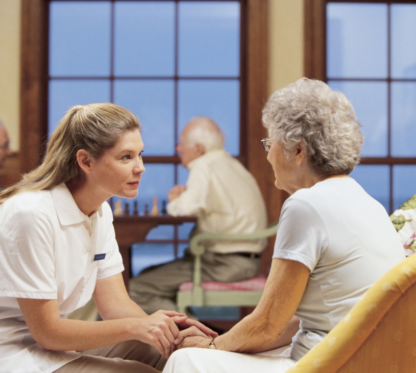 Healthcare professional assisting senior lady