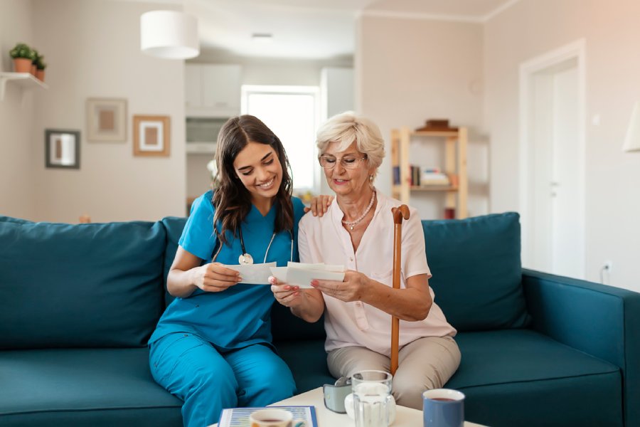 Nurse helping senior lady